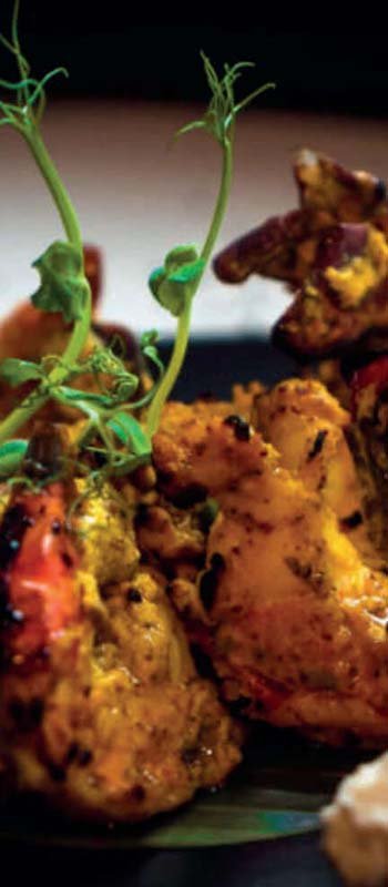 Tandoori chicken garnished with fresh herbs
