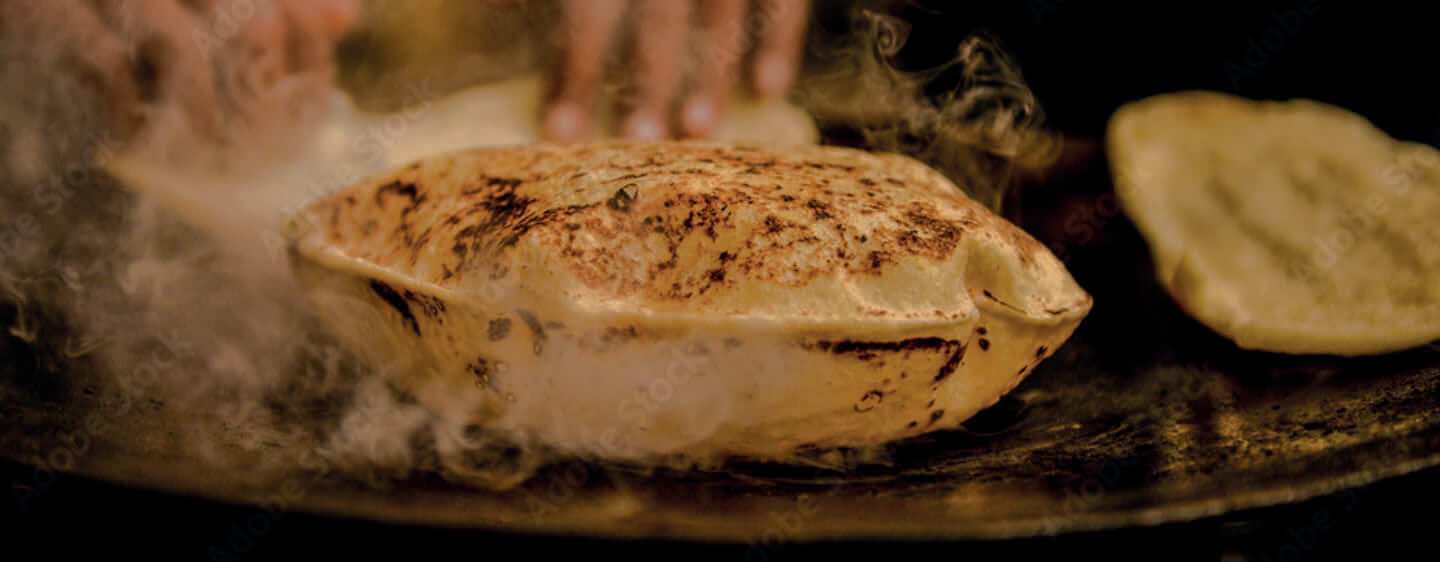 Naan bread puffing up on the tandoor